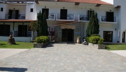 A view of the main entrance to the Alfa Hotel Parga which leads into the reception area and a large lounge area with a bar.