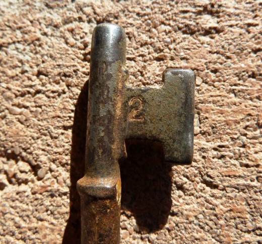 Old house key, on cheap house brick.