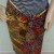 Tucking the end of a batik sarong side securely at the waist. Tucking the end of a batik sarong side securely at the waist.