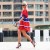 This fashionable woman takes sexy to another level in her street clothing as she flaunts a red and blue sports jersey with blue stilettos with straps. This fashionable woman takes sexy to another level in her street clothing as she flaunts a red and blue sports jersey with blue stilettos with straps.