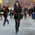 She is wearing see through black stockings with a green handbag and a hat. This is trendy street style. She is wearing see through black stockings with a green handbag and a hat. This is trendy street style.