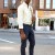 Attractive man wearing a sporty hat with black sunglasses and button up shirt playing flute street urban style. Attractive man wearing a sporty hat with black sunglasses and button up shirt playing flute street urban style.