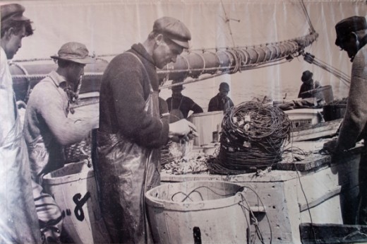 Fishermen working on a fishing vessel.