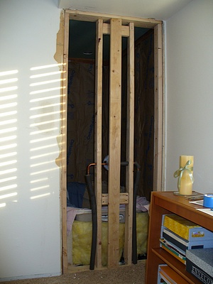 Rough in plumbing from the old door to the 'walk in closet' - the new tub is behind those 2" x 4" studs