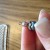 Wrap until you've nearly reached the beginning of your chain of beads, then use the very tip of your pliers to slightly bend the ring backwards to center the loop on your pin. It's easier to show than explain, and after a few you'll develop your own Wrap until you've nearly reached the beginning of your chain of beads, then use the very tip of your pliers to slightly bend the ring backwards to center the loop on your pin. It's easier to show than explain, and after a few you'll develop your own