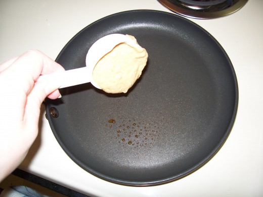 Measure out 1/4 cup of pancake batter onto a greased pan or skillet.
