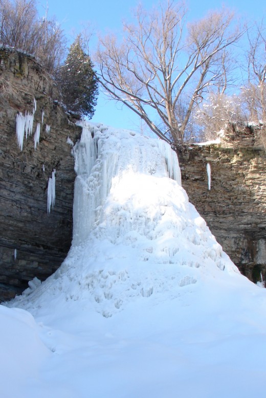Borer's Falls (in Hamilton) in winter completely covered in ice from top to bottom, front to back, yet water is flowing inside this cone or volcano!