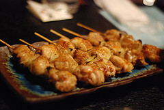 A sauce of sake - rice wine - mixed with Japanese soy sauce is poured over pieces of marinated chicken grilled on wooden skewers, just before serving.