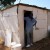 Amos at the door of the shack in Mamelodi which he shares with Gracious, their toddler, and Mercy