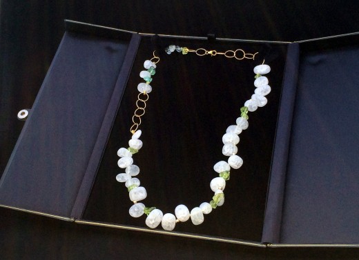 A properly stored crackle quartz necklace.  The box's tabs keep beads from knocking together. Photo courtesy Naiad Necklaces.