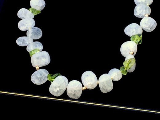 Crackle quartz beads with silk knots or soft gold spacers between each bead.  The knots and spacers prevent beads from hitting one another and chipping. Photo courtesy Naiad Necklaces.