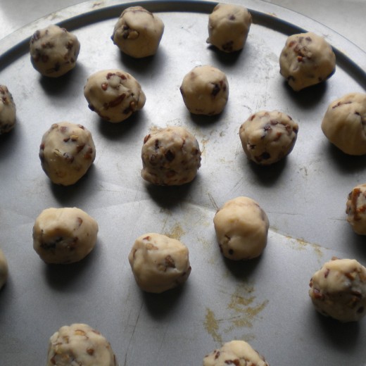 After 1 - 2 hrs...roll your cookie dough into inch size rounds with your hands and place on the cookie sheet or baking pan.