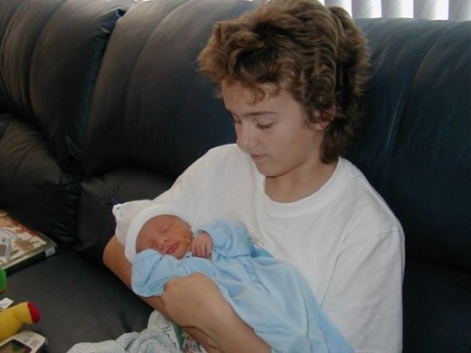 Big Sister Tori and Baby Christopher the day after he was born.  8/13/03