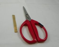 Brass strip with scissors