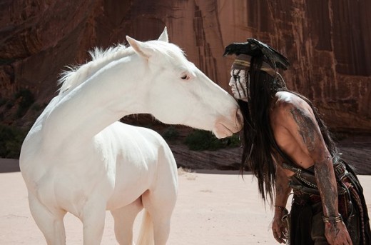 Johnny Depp engages in a staring contest with a white horse in "The Lone Ranger."