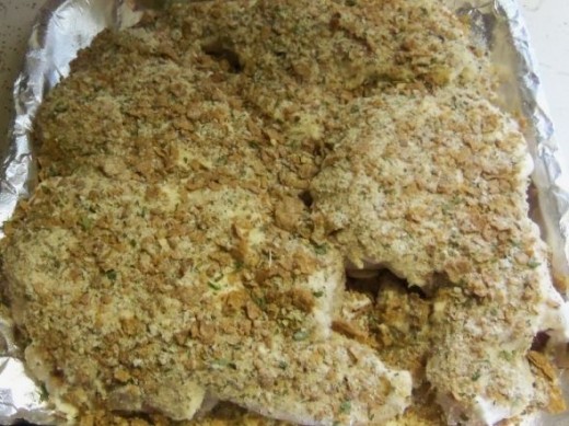 Spoon dry ingredients evenly over chicken, covering the entire piece on the top.