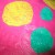 Yellow and green circles ironed on top of pink plastic bag.