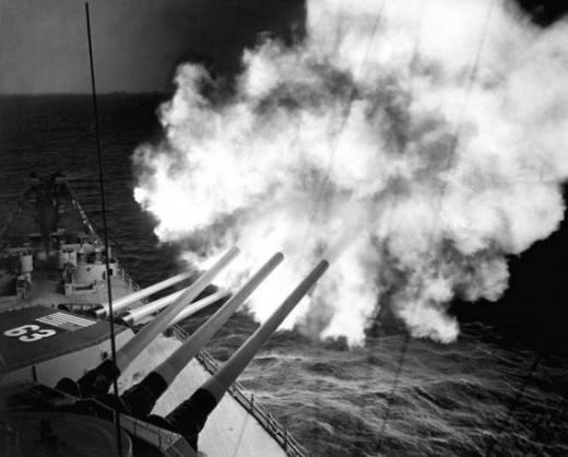 The USS Missouri fires 16-inch shell into enemy lines at Hungnam 1950