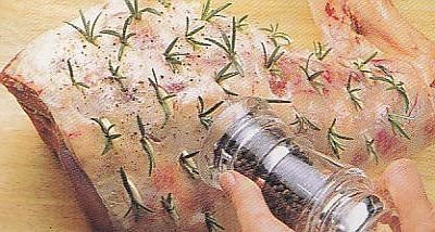 Add rosemary sprigs to the lamb leg