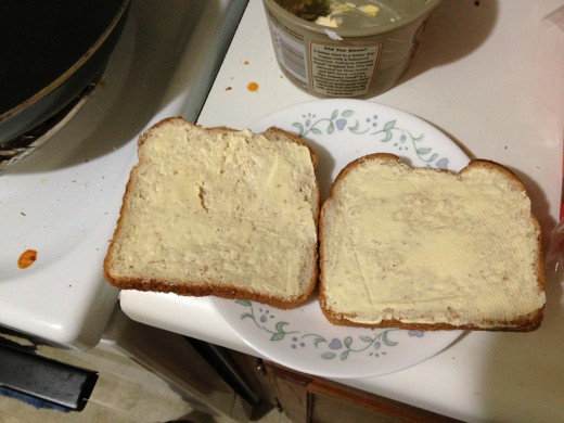 The outside of each piece of bread gets buttered.
