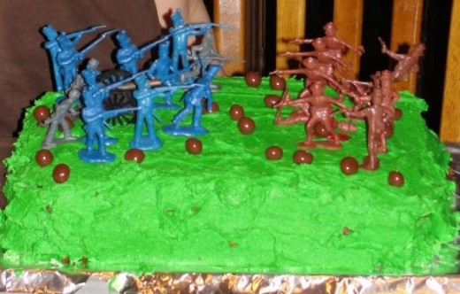 This is probably the easiest option.  Add some green food coloring to vanilla frosting.  Top the cake with army men.  My oldest son decorated this.  He added peanut butter ball "cannon balls" and red icing "blood."