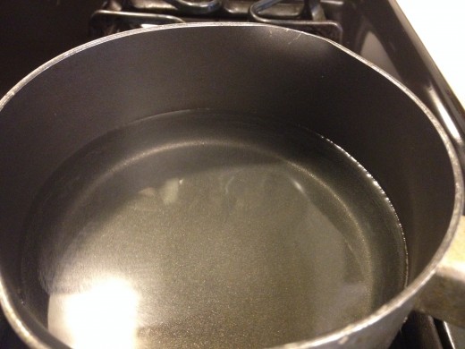 Water in pan being heated to a boil for homemade dish soap if using bar soap
