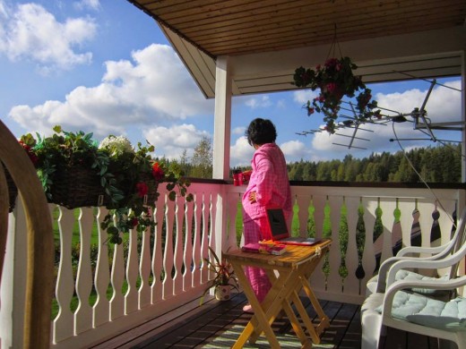 Enjoying the view of the Finnish forest,taking it easy from terrible jetlag and a good cup of Starbucks coffee I brought from the States.Terrace next to my room in  Sipoo,Finland.