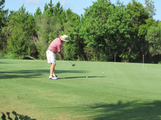 My next victim for the goofy putting ball trick. Here's my husband practicing his putting before we head out for 18 holes. 
