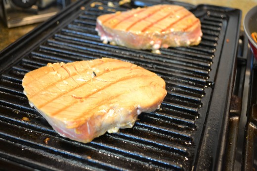 Searing fresh tuna steaks on my indoor grill pan.