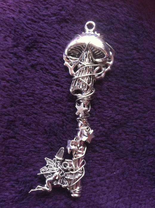 This mystical key pendant- A magical mushroom with small fairy and hand twisting and weaving wire with stars in order to create eye catching and unique neckless.  Pendant measures 7 cm including the bail and it can be added to a chain and suspended.
