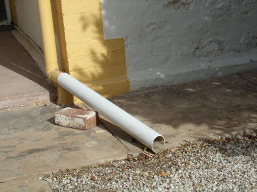 pvc downpipe extension on a house near the beach