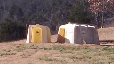 Portable, polyvinyl, calf hutches work well for small groups of goats. The ones pictured above are used for bucks.