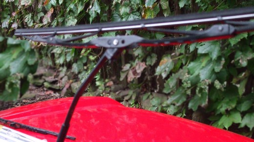 Windshield wiper arm is perpendicular to window and blade assembly is almost perpendicular to wiper arm. Windshield wiper arm is perpendicular to window and blade assembly is almost perpendicular to wiper arm.