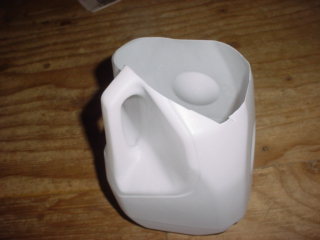 Cut off Plastic Milk Jug for catching water from tank