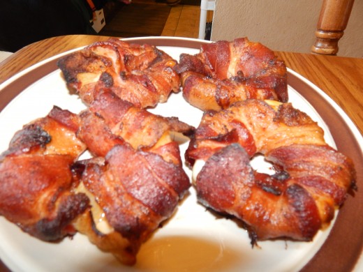 Here is a completed plate of four bacon appetizers ready to be served.
