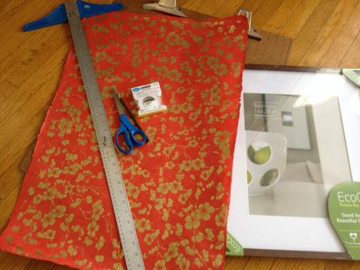 Supplies you will need: Art paper, T-square, sharp paper scissors, pencil, mounting tape, picture frame with glass, protective surface on which to score and cut the paper
