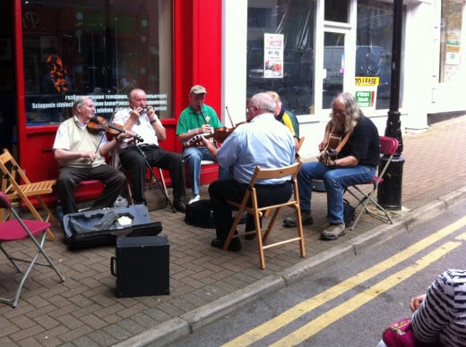 Joining in a session of buskers playing Irish traditional music.