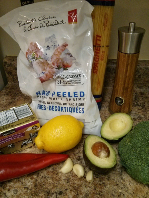 Frozen shrimp, lemon, avocado, red pepper, garlic, pepper, pasta, broccoli, butter (missing: olive oil and parmesan from the picture!)