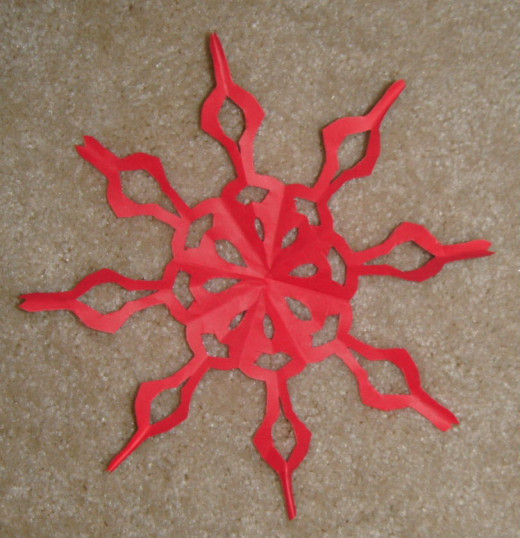 An eight pointed snowflake with light bulb ends