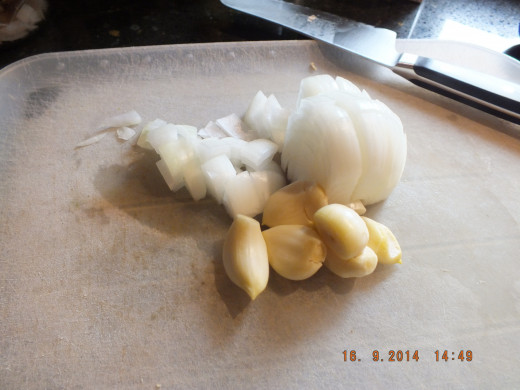 While the tofu is baking, prepare the rest of the ingredients. Chop you onion and mince the garlic. 