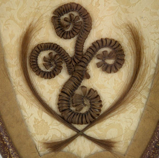 Mourning Wreath made of human hair, framed behind glass