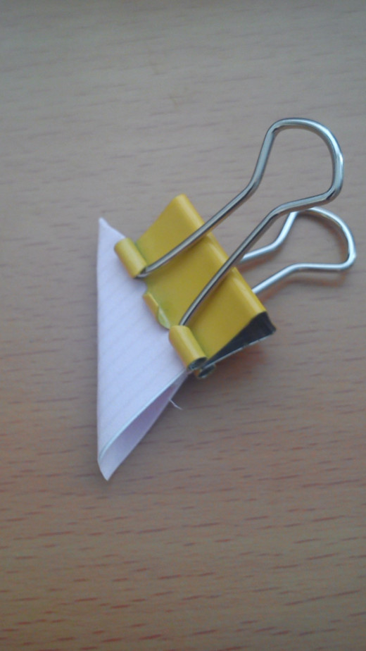 Hold in place with a bulldog clip or paper clip until glue has dried.