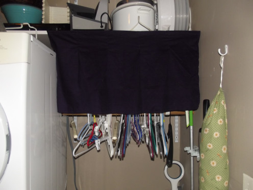 These pleated curtains were easy to make and create instant hidden storage.  Velcro tabs glued onto the shelf and sewn into the curtain holds the curtain firmly in place.  