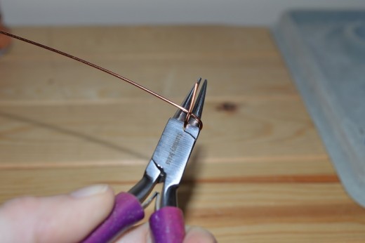 Making a loop in the wire using the round nose pliers