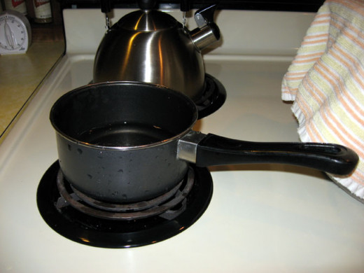 Melt the wax on low heat in a small pot. You'll have to break it out of the coffee can with a knife. Melt about a fourth of a can of wax at at time - enough for one dozen and a half sized egg carton.