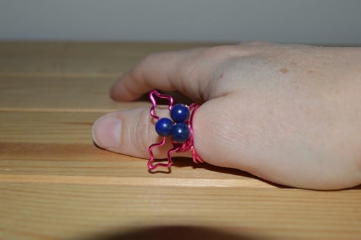 For this ring I used fuchsia colour wire, with blue lapis lazuli gemstone beads