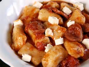 Gnocchi in tomato sauce sprinkled with feta cheese