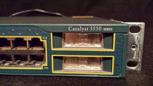 The 2XGBIC ports, close-up.  You purchase the Gigabit modules and slide them in.   There is a socket deep inside, at the back of these slots.