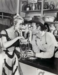Dennis Weaver, "Chester Goode," enjoys a drink at the Long Branch Saloon on Gunsmoke
