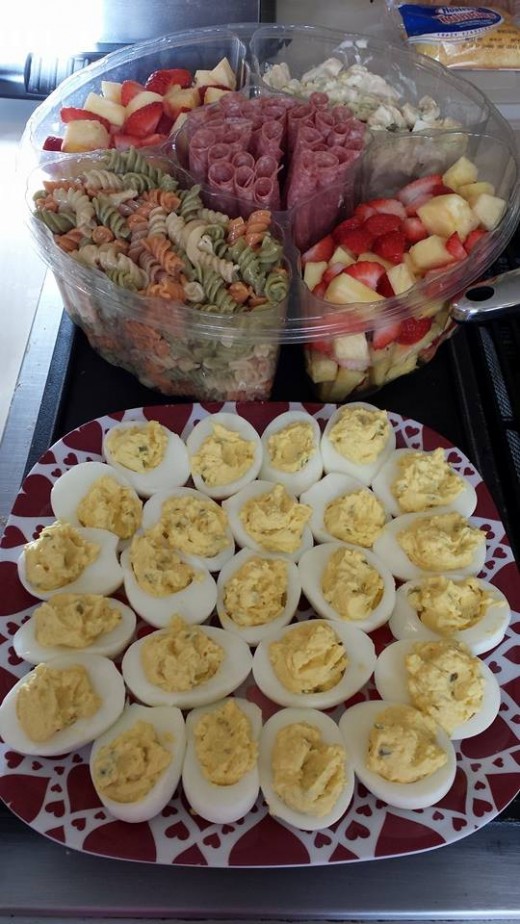 Pasta salad (noodles, Italian dressing, Parm. cheese), deviled eggs (egg center, mustard, mayo, pickles), pineapples/strawberries/grapes, salami with cream cheese center, chicken salad (cooked and diced chicken with mayo/egg whites/celery/pickle).